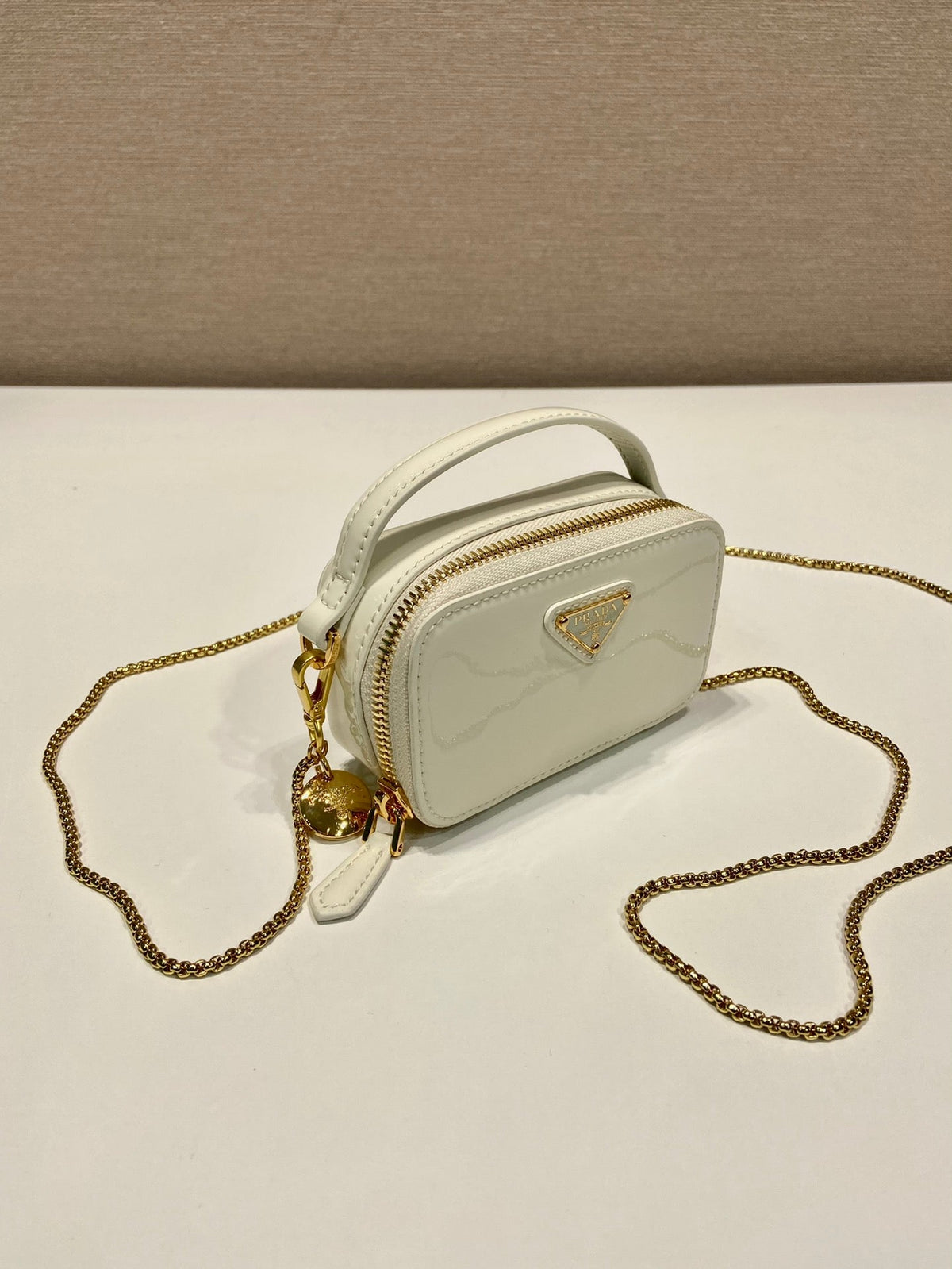 MINI HAND BAG 11 WITH GOLD STRAP IN WHITE PATENT CALFSKIN
