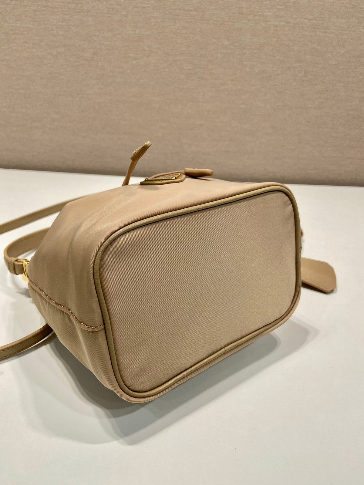 BUCKET BAG 19 IN BEIGE RE-NYLON AND SAFFIANO LEATHER HANDLE