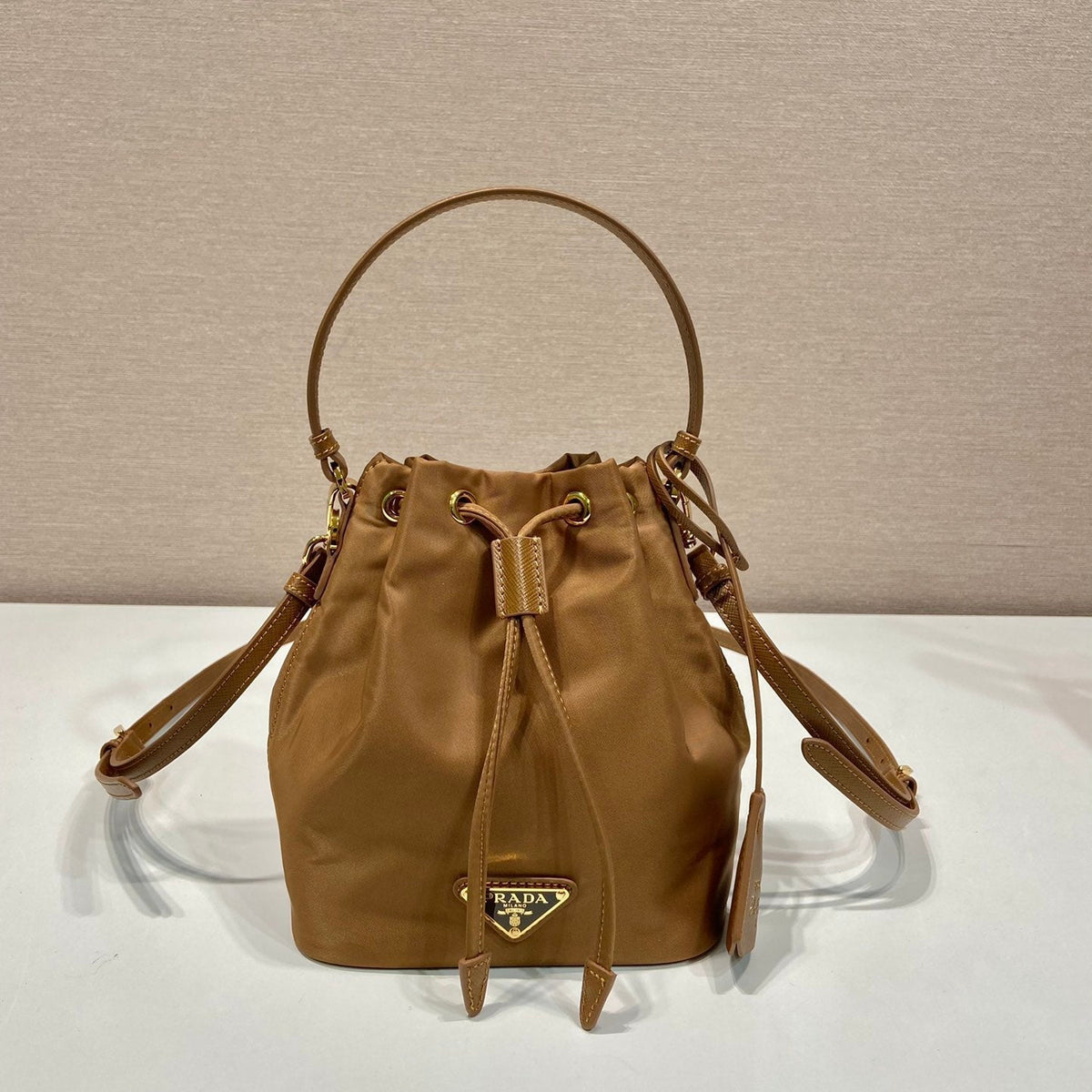 BUCKET BAG 19 IN RUSSET BROWN RE-NYLON AND CALFSKIN HANDLE