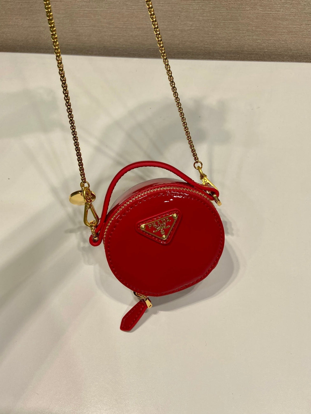MINI ROUND BAG 8 IN RED GLOSSY CALFSKIN GOLD HARDWARE