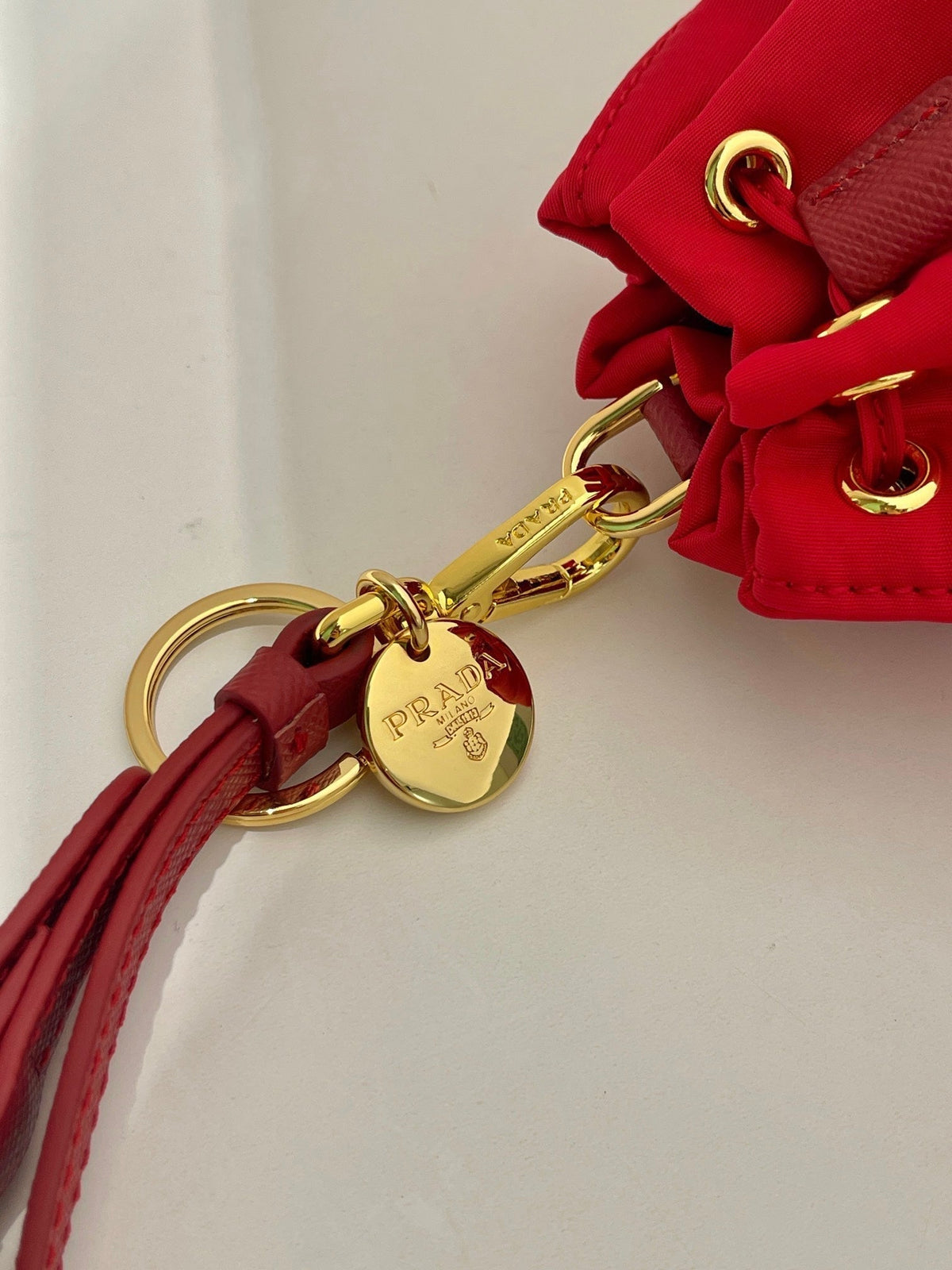 MINI BUCKET BAG 10 IN RED RE-NYLON AND SAFFIANO LEATHER STRAP