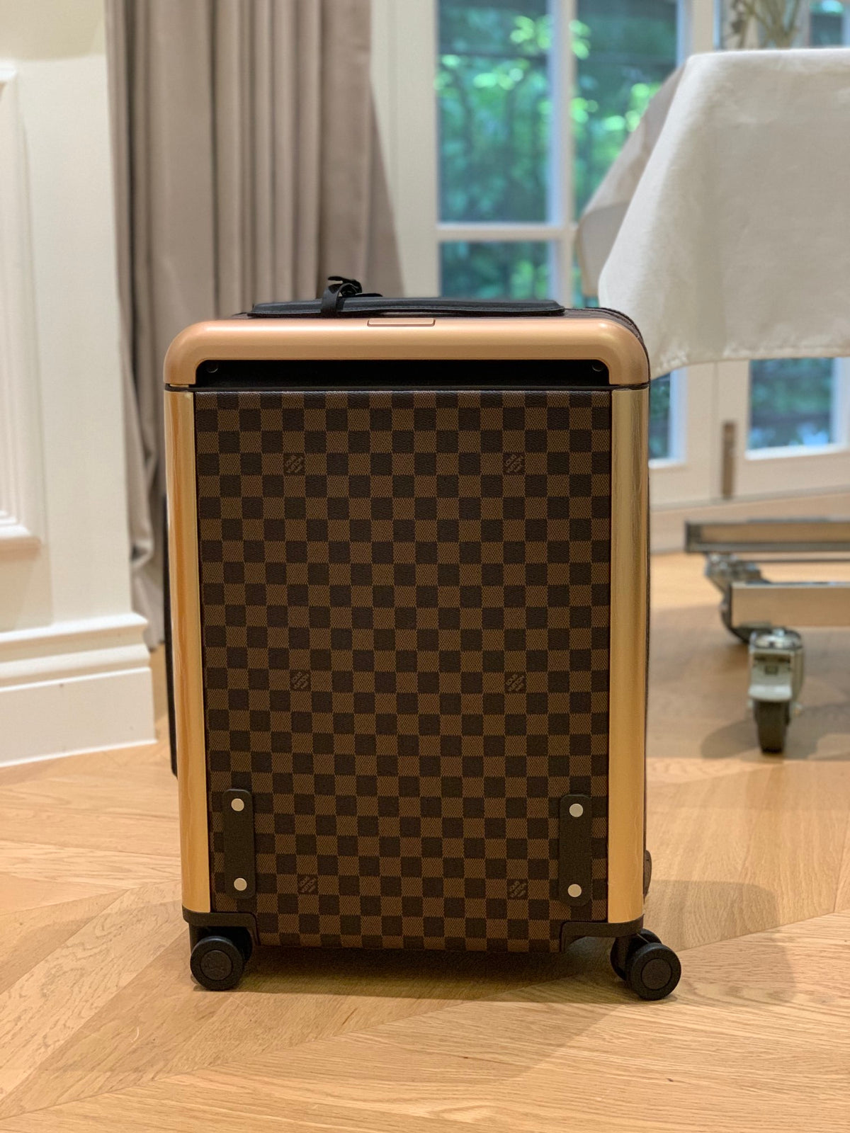Louis Vuitton Horizon 55 rolling suitcase in Damier Ebene canvas.