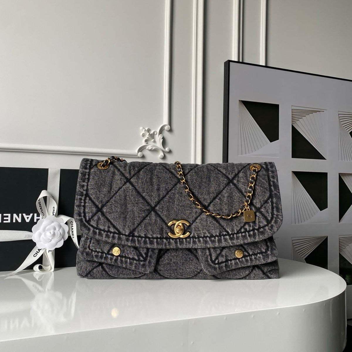 Chanel Maxi Flapbag in washed denim with gold-tone metal hardware