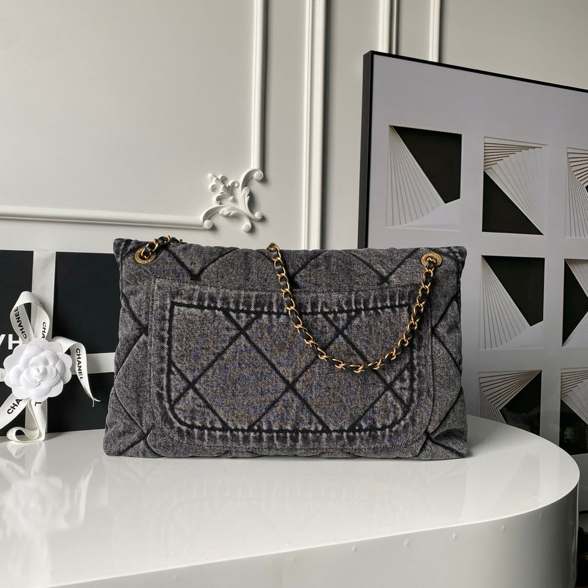 Chanel Maxi Flapbag in washed denim with gold-tone metal hardware