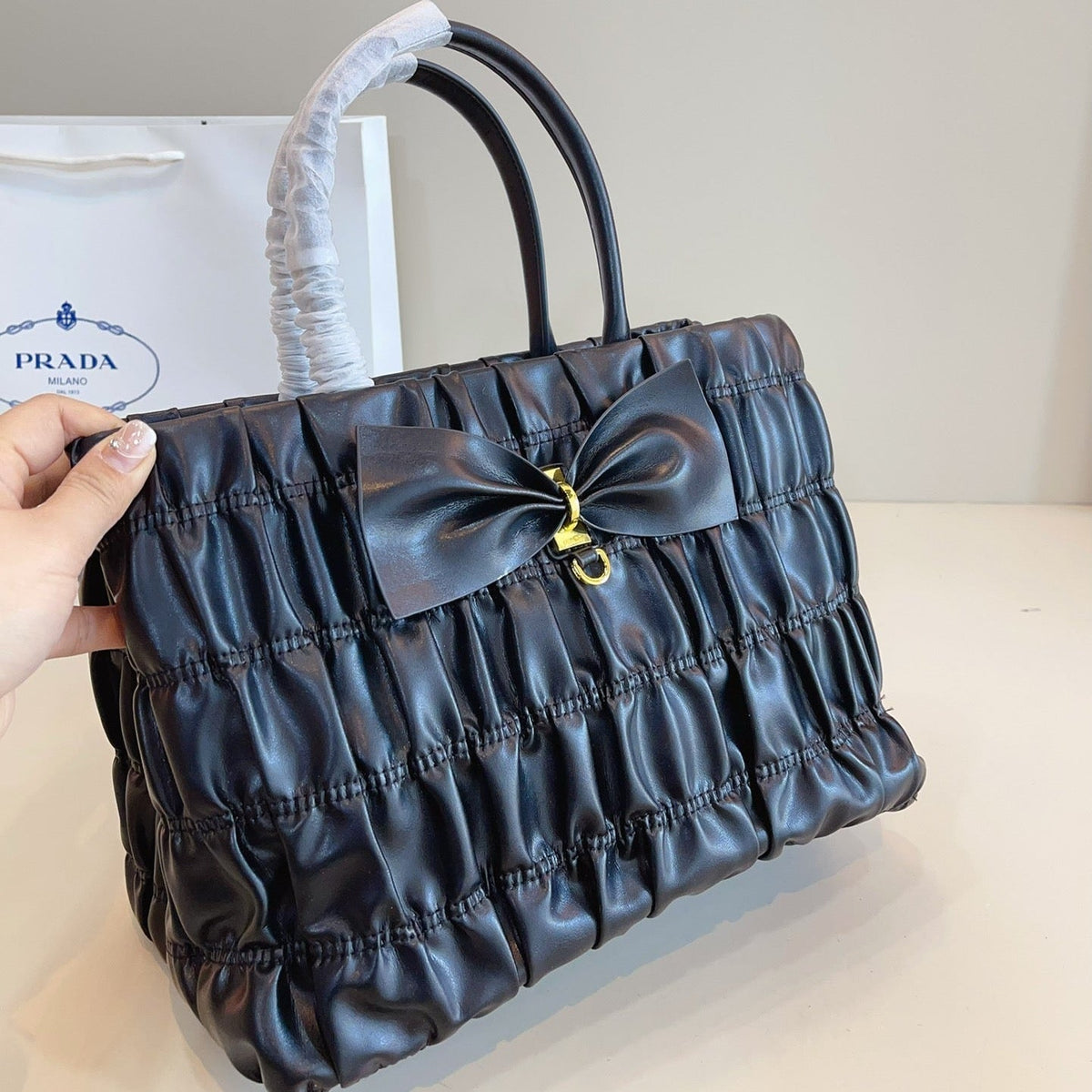 BOW DETAIL RUCHED TOP HANDLE BAG 29 IN BLACK SAFFIANO LEATHER