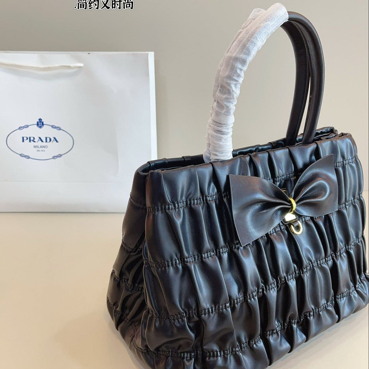 BOW DETAIL RUCHED TOP HANDLE BAG 29 IN BLACK SAFFIANO LEATHER