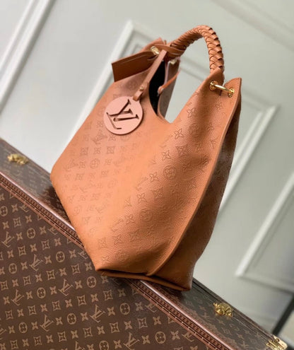 Louis Vuitton Carmel Mahina Leather Hobo Bag in Cognac