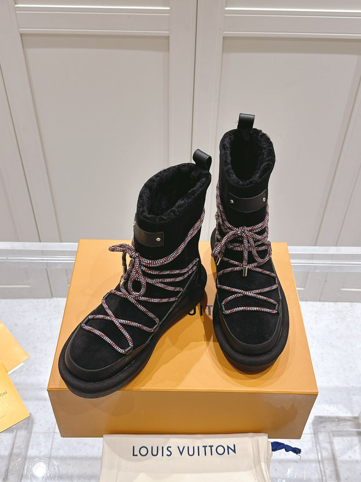ASPEN PLATFORM ANKLE BOOT IN BLACK MONOGRAM DEBOSSED SUEDE AND SHEARLING
