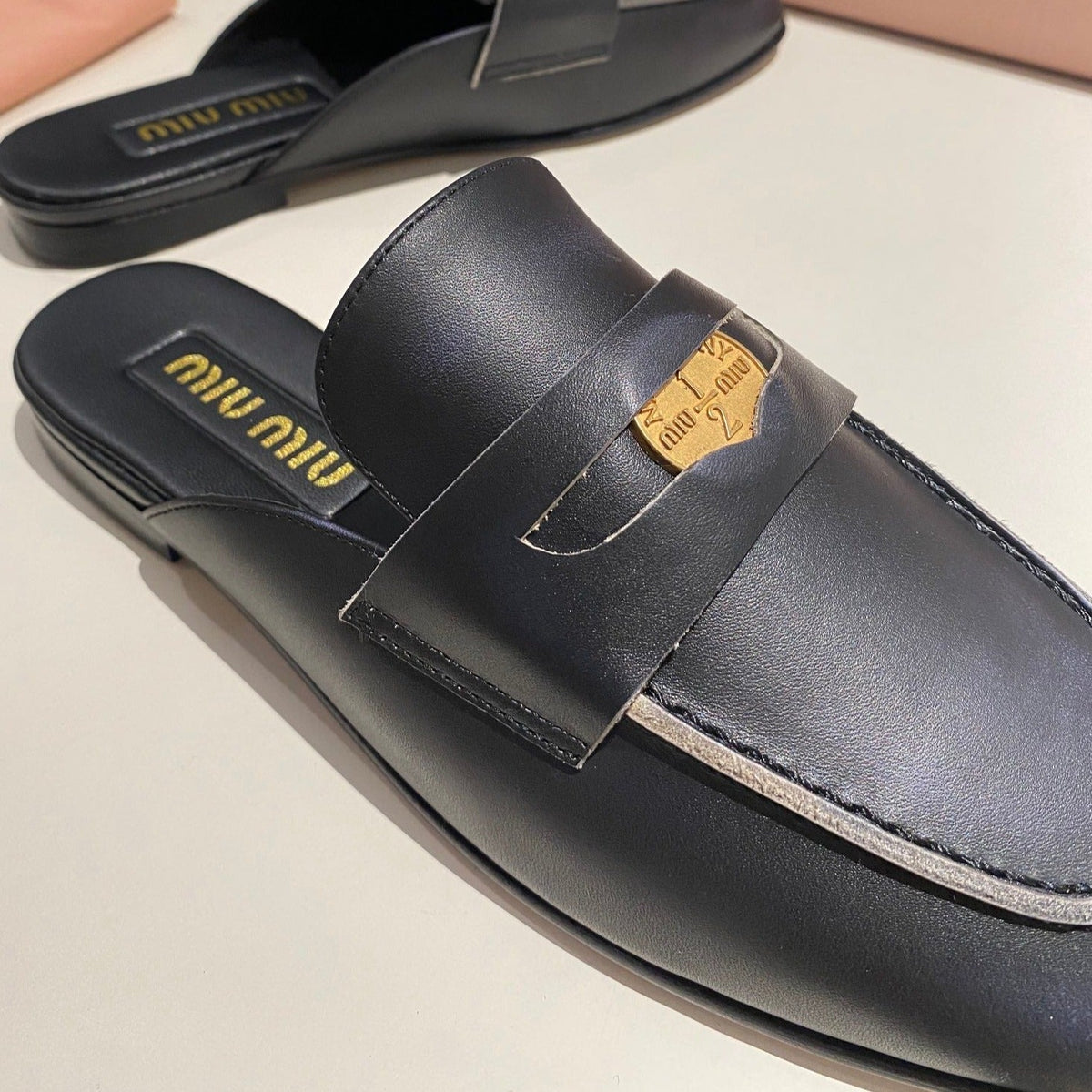 MULES SLIPPERS BLACK COWHIDE WITH GOLD COIN
