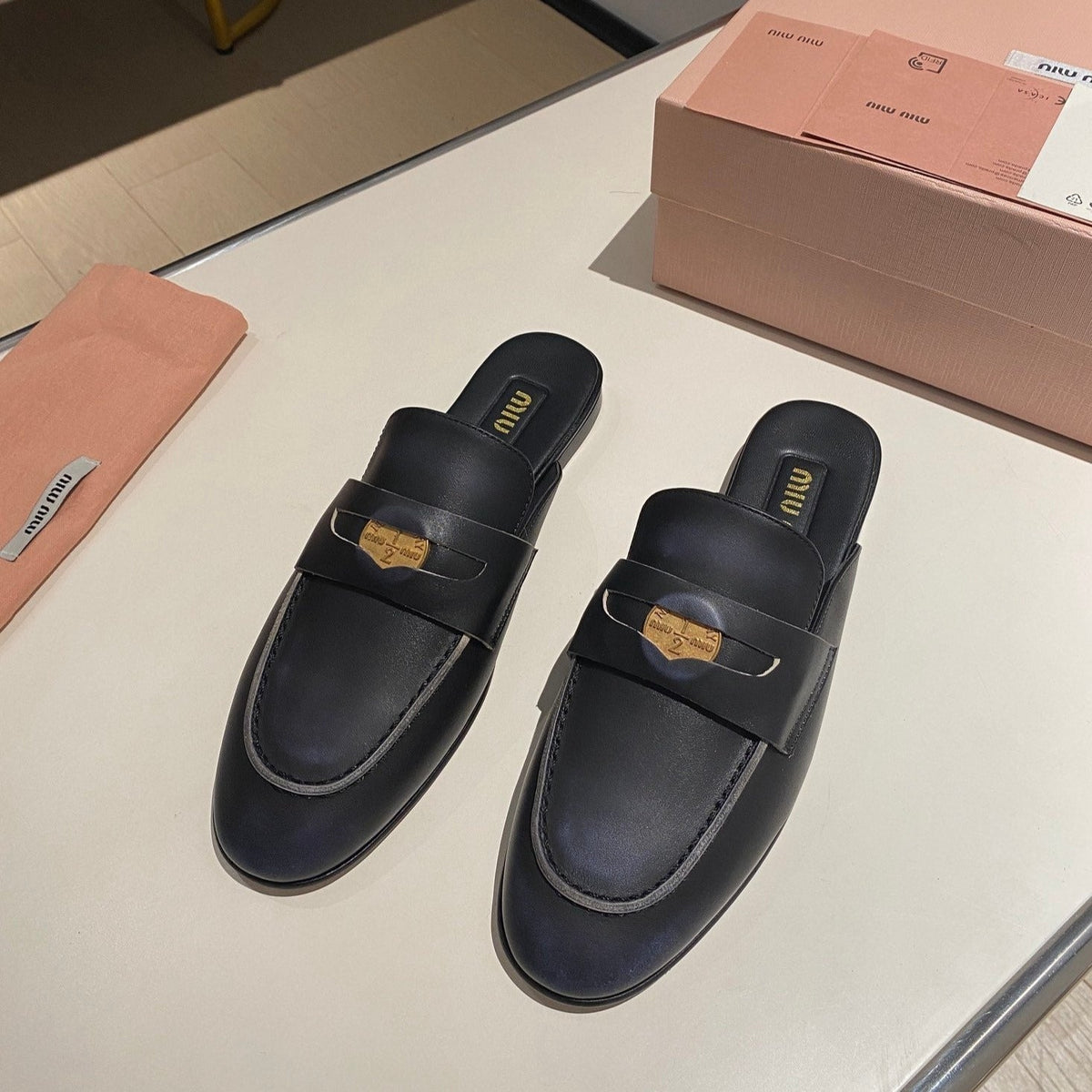 MULES SLIPPERS BLACK COWHIDE WITH GOLD COIN