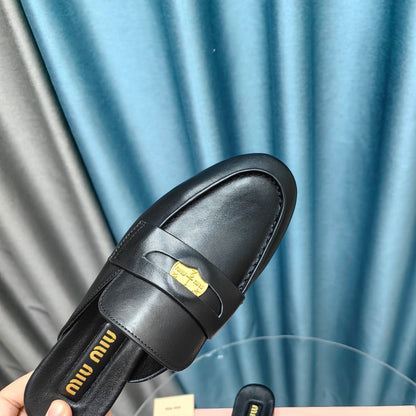 MULES SLIPPERS BLACK COWHIDE WITH GOLD COIN