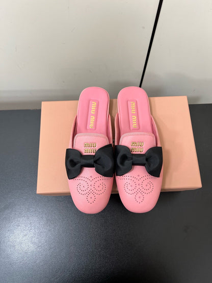 BOW MULES IN PINK SHEEPSKIN