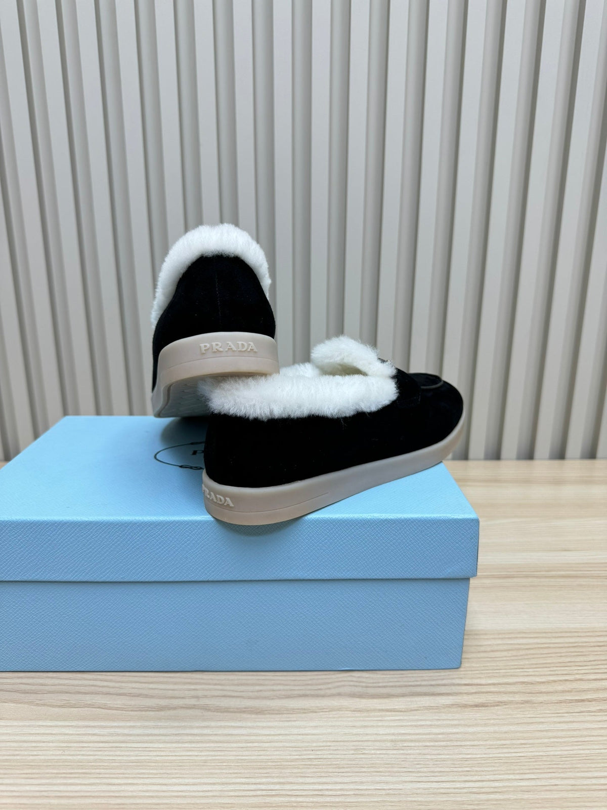 LOAFER IN BLACK SUEDE AND FUR LINING ATTACHED TRIANGLE LOGO
