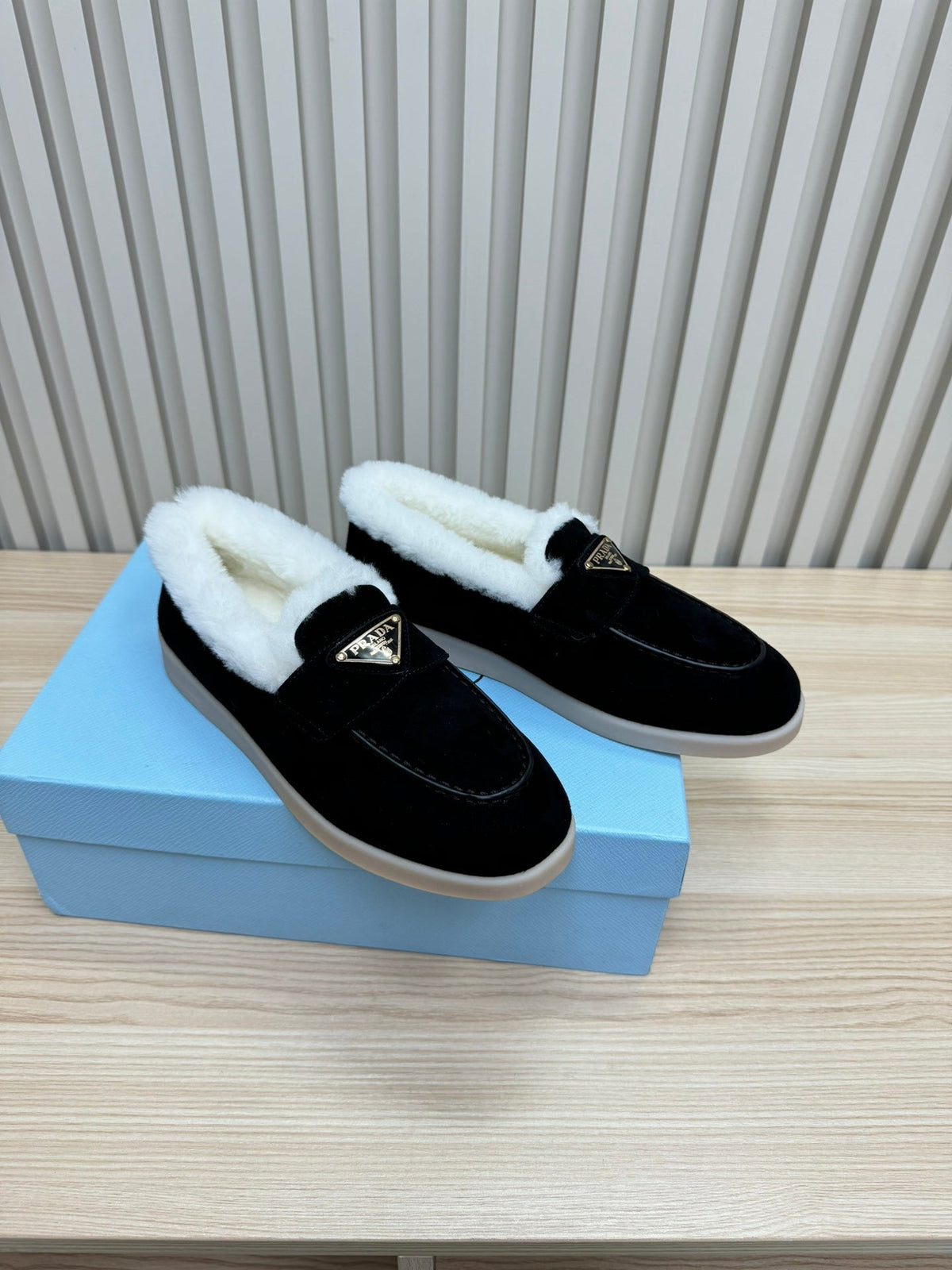 LOAFER IN BLACK SUEDE AND FUR LINING ATTACHED TRIANGLE LOGO