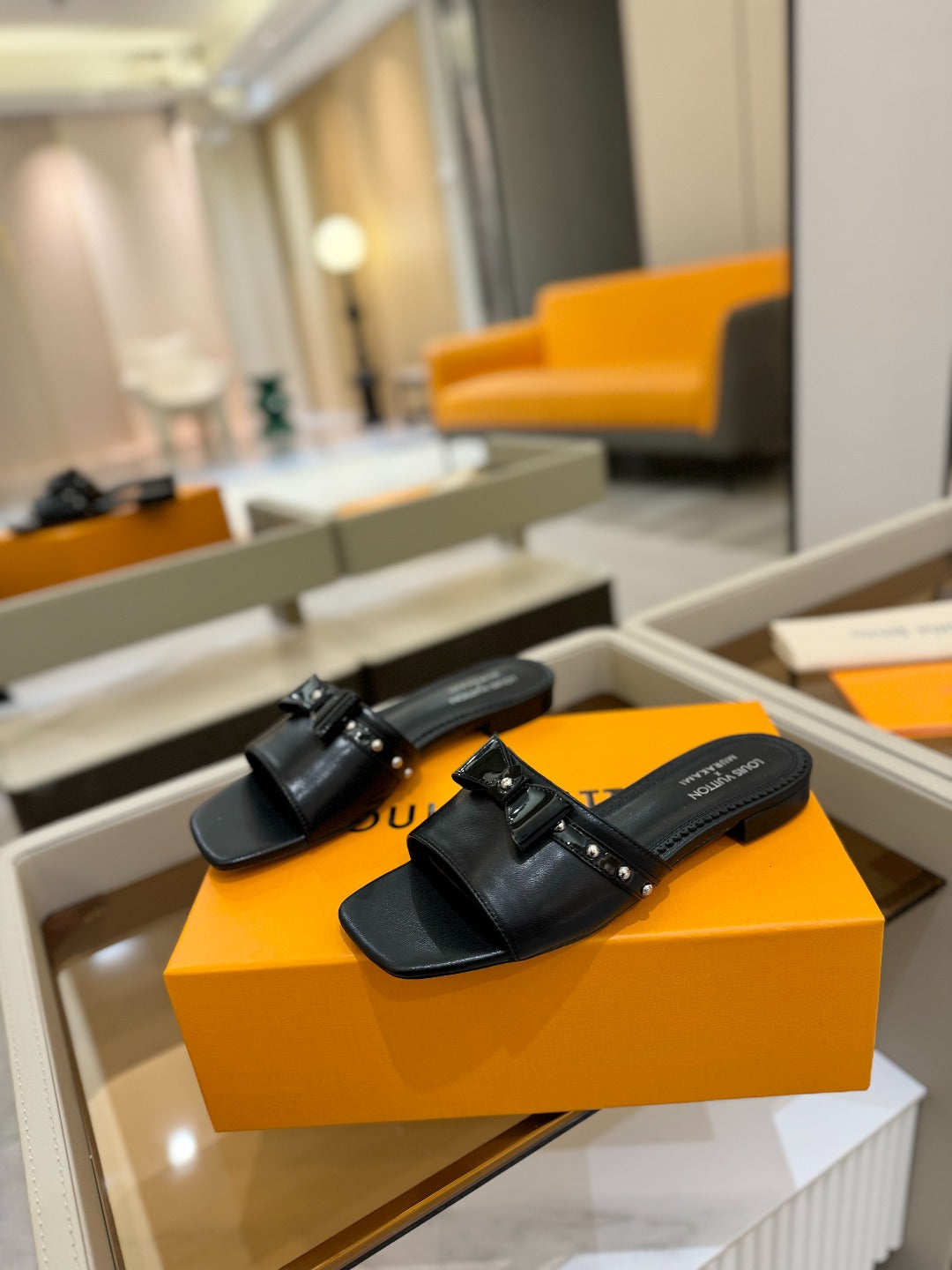 LV X TM 6AM FLAT MULE IN BLACK CALFSKIN