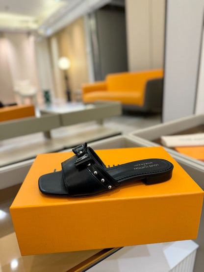 LV X TM 6AM FLAT MULE IN BLACK CALFSKIN
