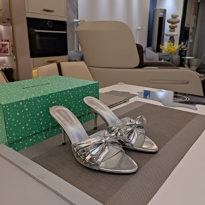 BOW-EMBELLISHED HIGH MULES IN SILVER METALLIC SHEEPSKIN