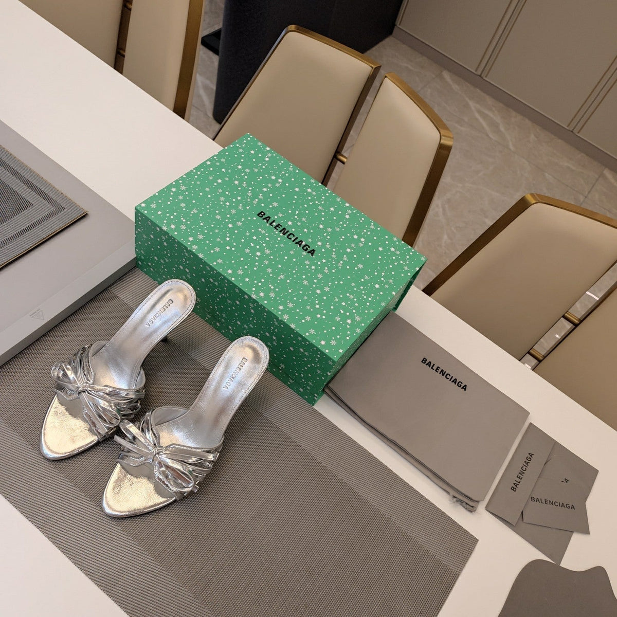 BOW-EMBELLISHED HIGH MULES IN SILVER METALLIC SHEEPSKIN