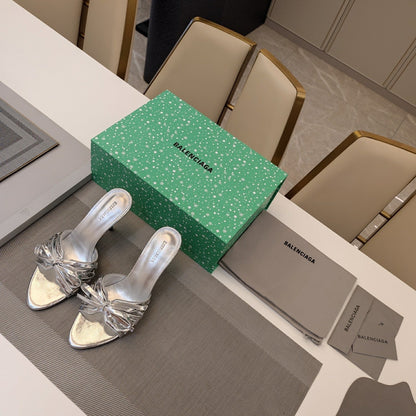 BOW-EMBELLISHED HIGH MULES IN SILVER METALLIC SHEEPSKIN